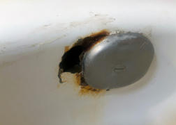 rusted and chipped bathtub overflow