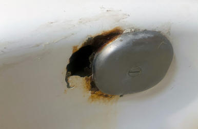 rusted and chipped bathtub overflow